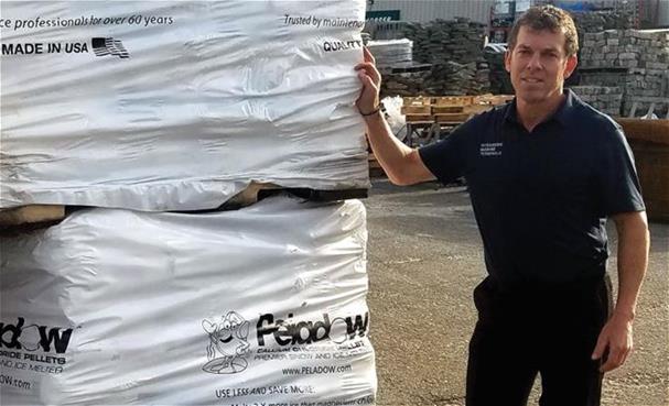 Vic Liotta, President at OMT Marine Terminals, LLC in Oceanside, New York standing next to a pallet of OxyChem PELADOW&reg; Calcium Chloride